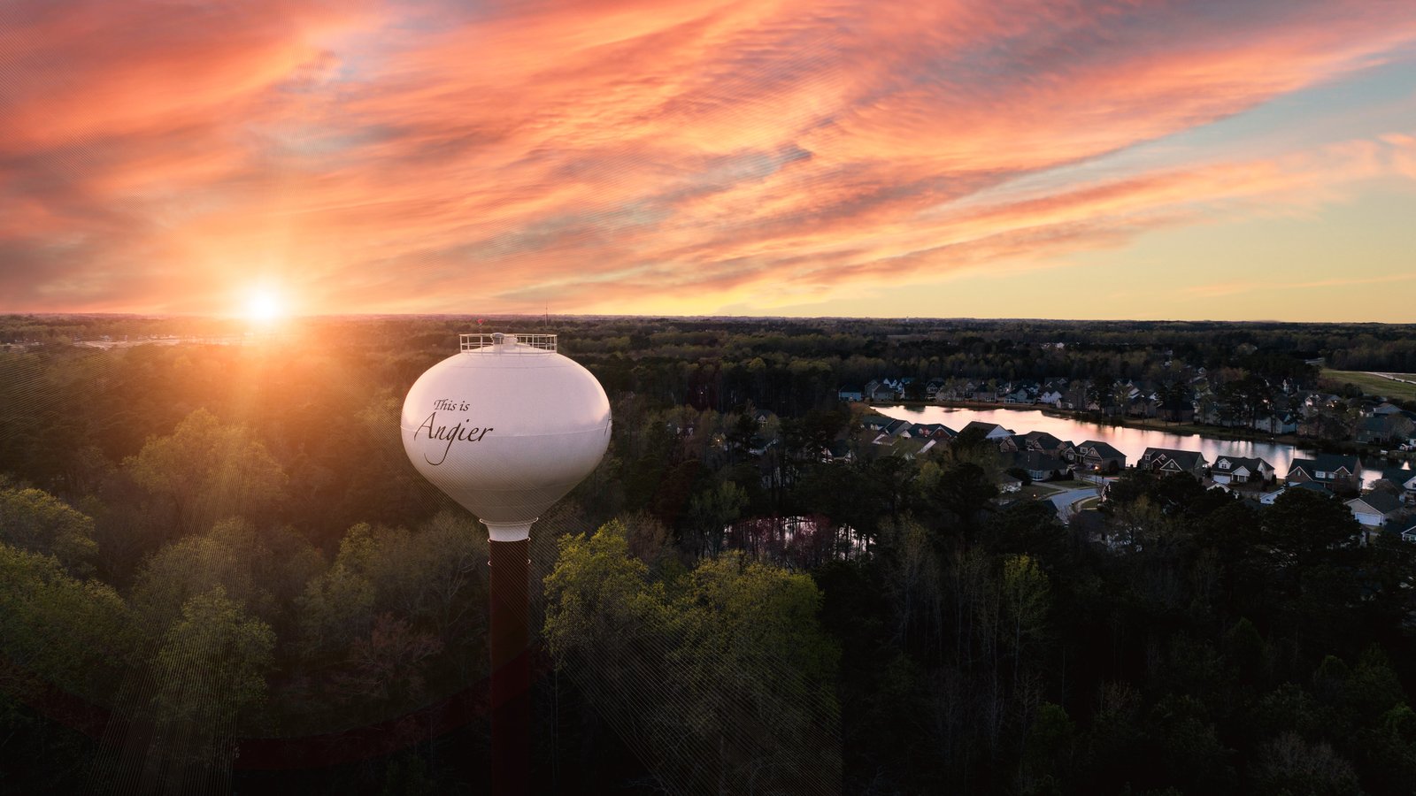 Aerial shot of Angier water tower at sunset